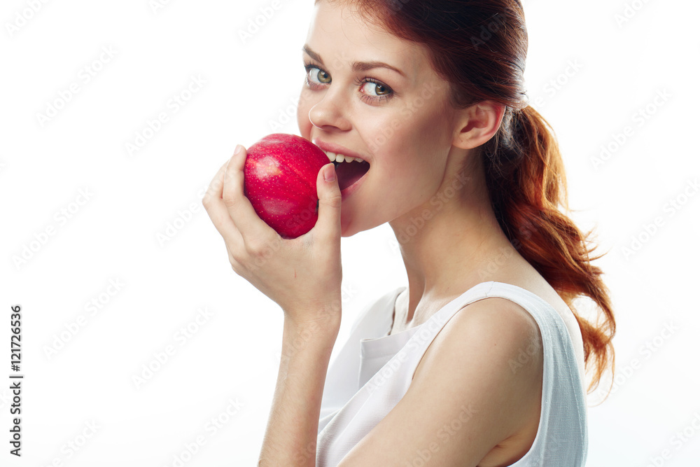 Beautiful young woman eating an apple
Beautiful young woman eating an apple
