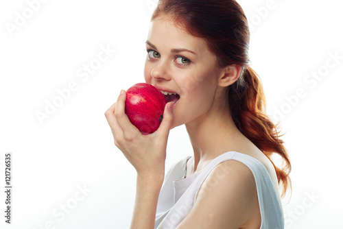 Beautiful young woman eating an apple 