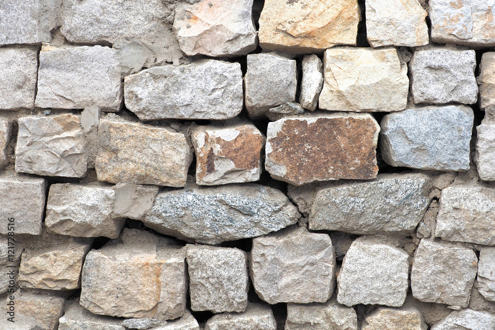 Ancient stone wall built for exterior for background Ancient stone wall built for exterior for background