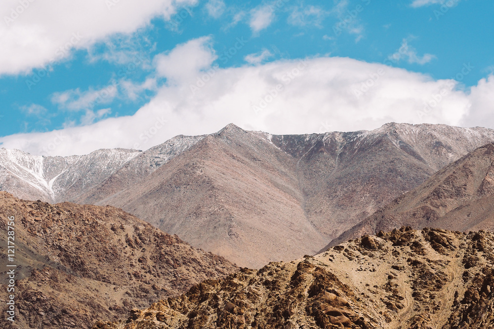 Top of rock mountain in blue cloud sky - with copyspace in Leh, Ladakh, India