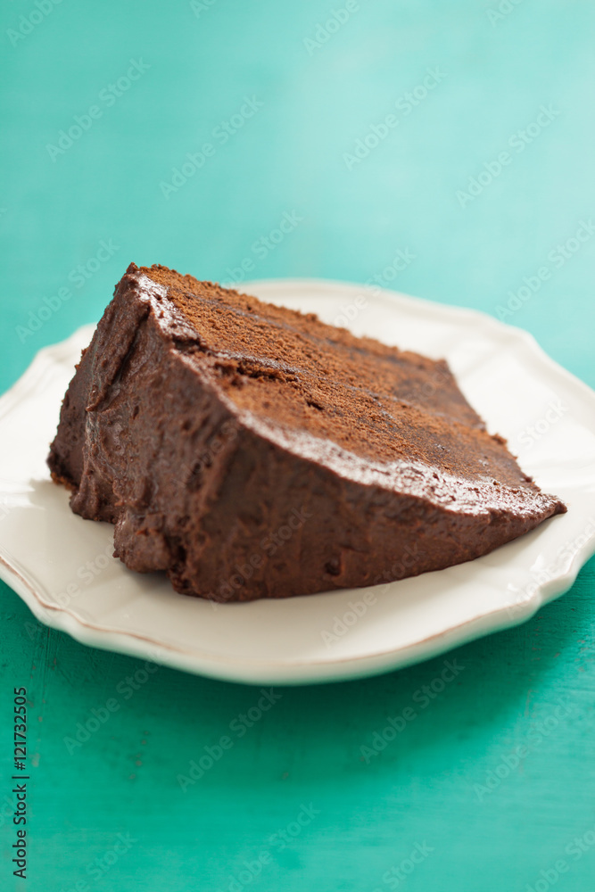 Homemade chocolate cake with cream and dark chocolate, closeup, selective focus Homemade chocolate cake with cream and dark chocolate, closeup, selective focus