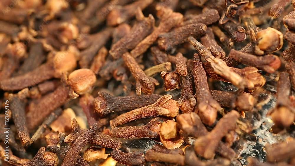 Pile of flavorful dried cloves, aromatic additive to dishes and hot beverages Pile of flavorful dried cloves, aromatic additive to dishes and hot beverages
