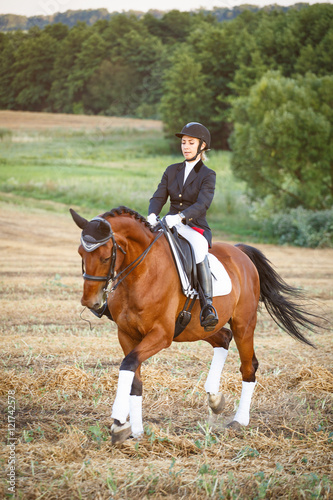 woman riding a horse. Equestrian sportswoman jockey © serkucher