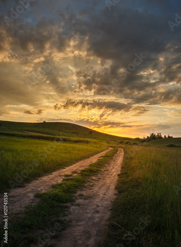 Road in steppe to sunset