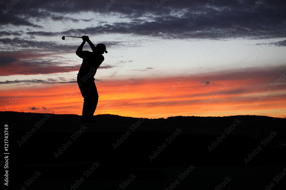 Golfer playing golf during sunset at competition event
