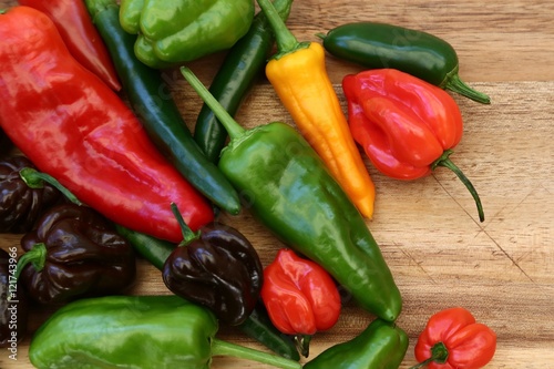  a colorful mix of the hottest chili on wood background photo