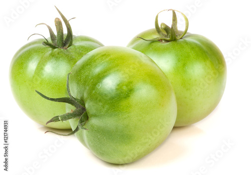 Three green unripe tomato isolated on white background