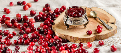 Cranberries and jam in a silver jar