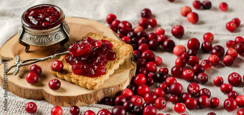Breakfast with cranberries, jam and biscuits.