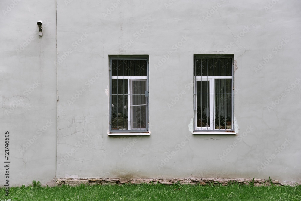 gray wall with two windows