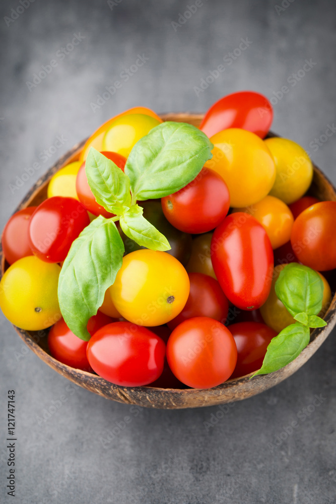 Tomatoes on the gray background. Colorful tomatoes, red tomatoes Tomatoes on the gray background. Colorful tomatoes, red tomatoes