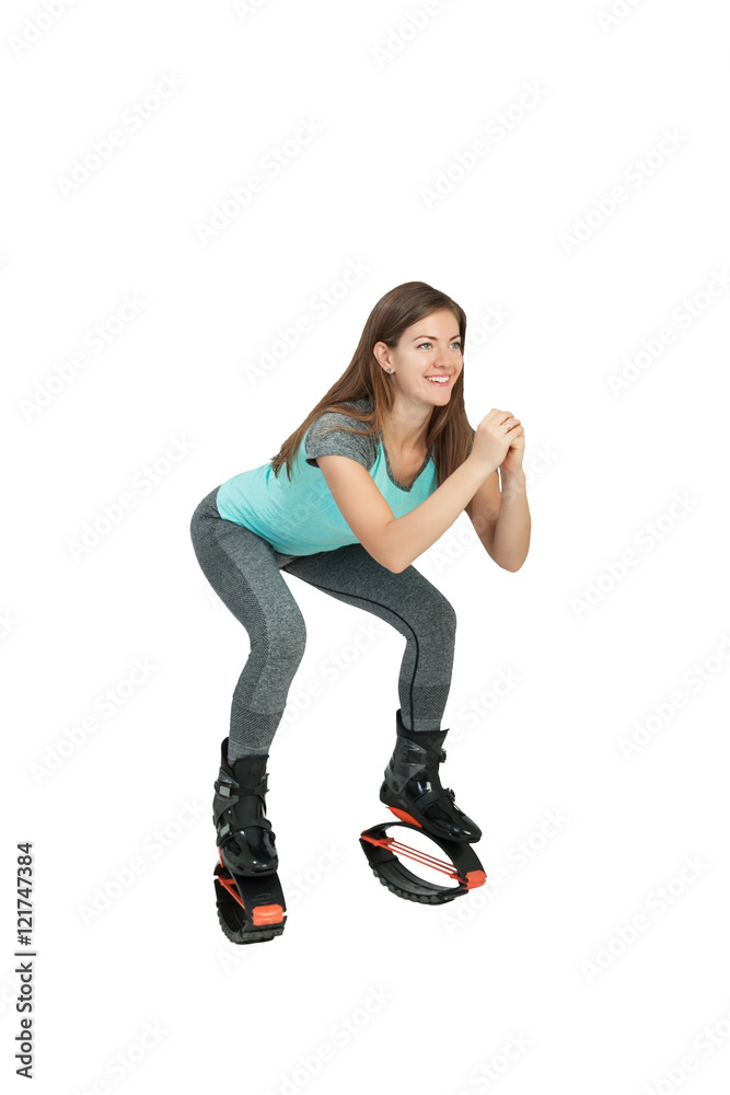 Girl crouches in boots kangoo jumps Girl crouches in boots kangoo jumps