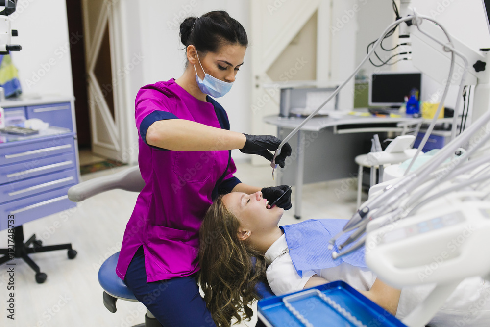 Dentist curing a female patient Dentist curing a female patient