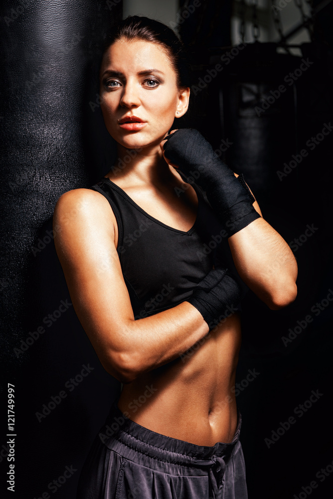 Young fitness beautiful brunette girl with boxing gloves in the gym Young fitness beautiful brunette girl with boxing gloves in the gym