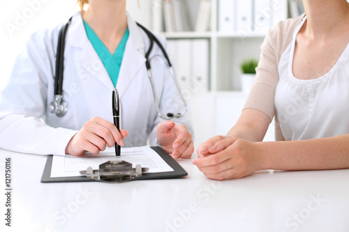 Doctor and patient are discussing something, just hands at the table