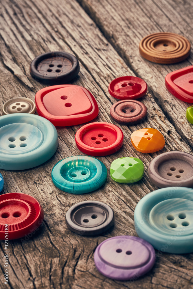 Buttons on wooden background Buttons on wooden background