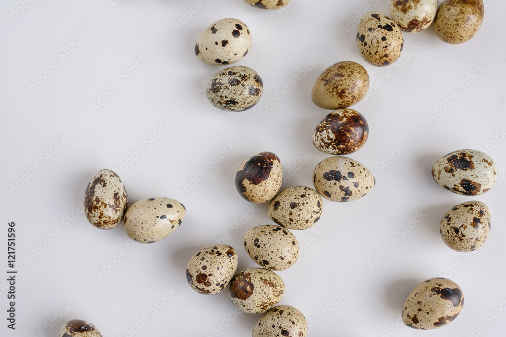Pile of raw quail eggs isolated on white background
