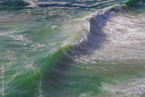Top view of isolated emerald ocean waves with white foam, Praia