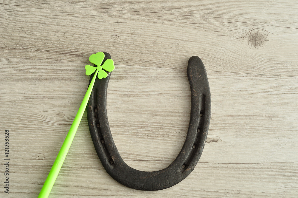 A horseshoe displayed with a four leaf clover for St. Patrick's