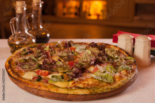 Tasty pizza on wooden tray