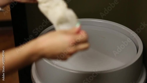 Nurse Throwing Latex Gloves in the Trash