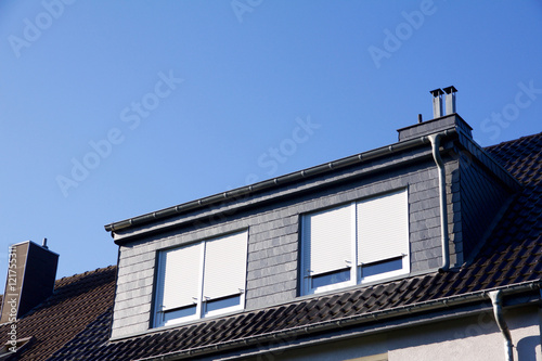 Closeup view on a house with dormer windows, shutter down photo