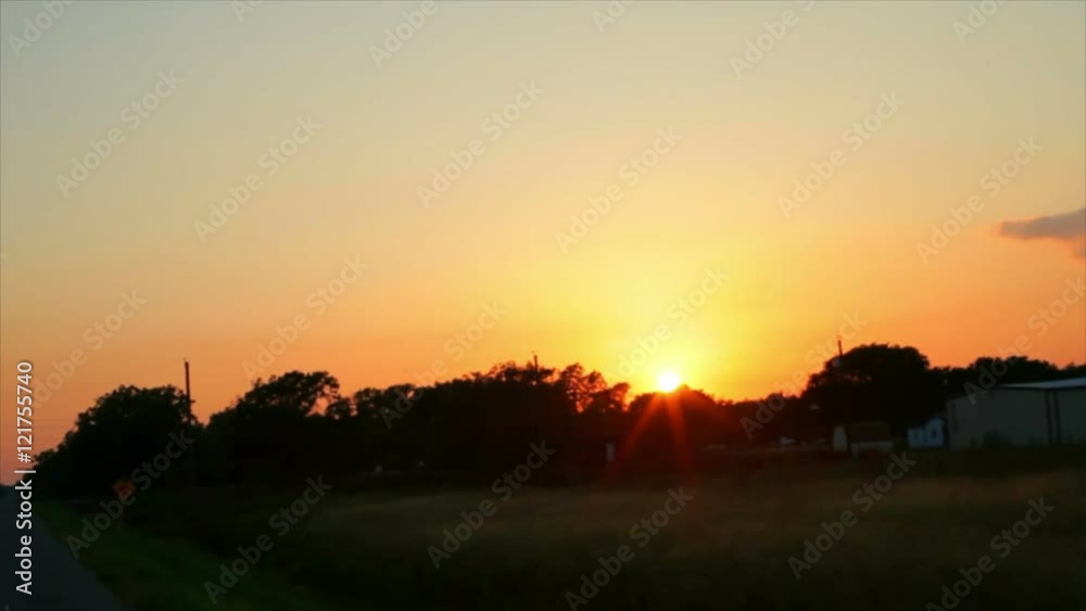 A lazy Texas sun just before sunset appears to follow travelers along a rural stretch of highway. A lazy Texas sun just before sunset appears to follow travelers along a rural stretch of highway.