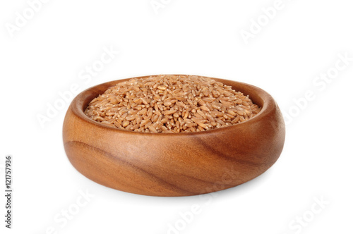 cereal spelled in wooden bowl on a white background. ingredient for a healthy lifestyle. 