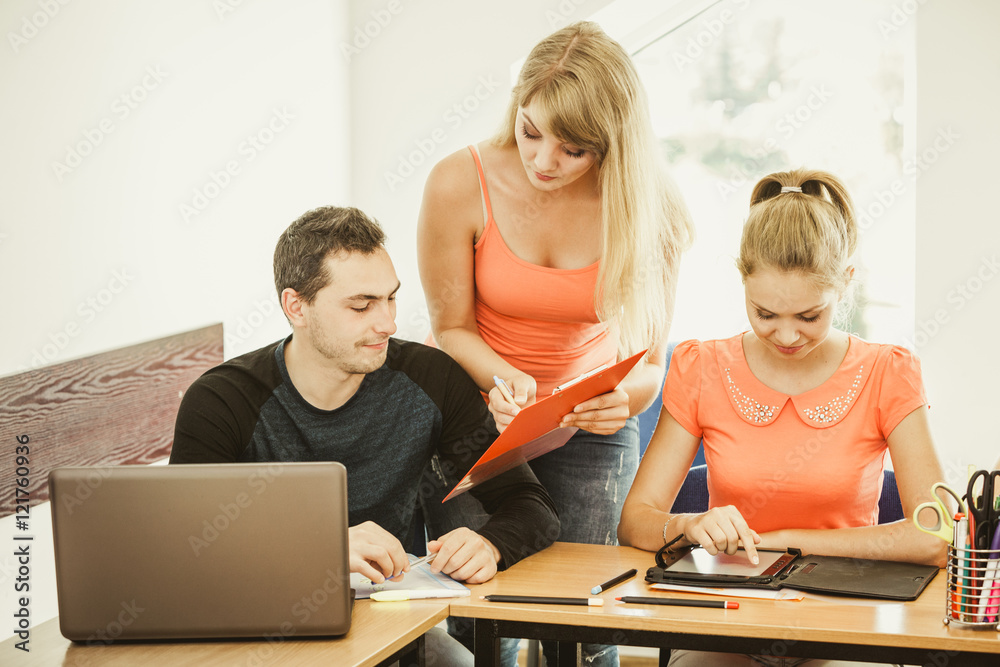 Students and teacher tutor in classroom Students and teacher tutor in classroom