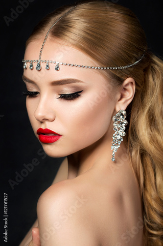 Portrait of young beautiful woman with evening make up