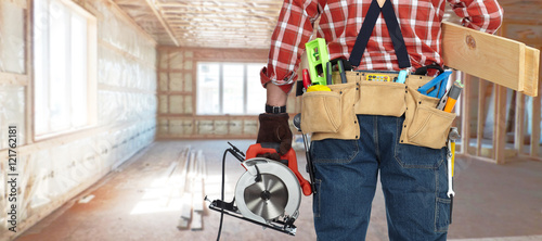 Builder handyman with electric saw. photo