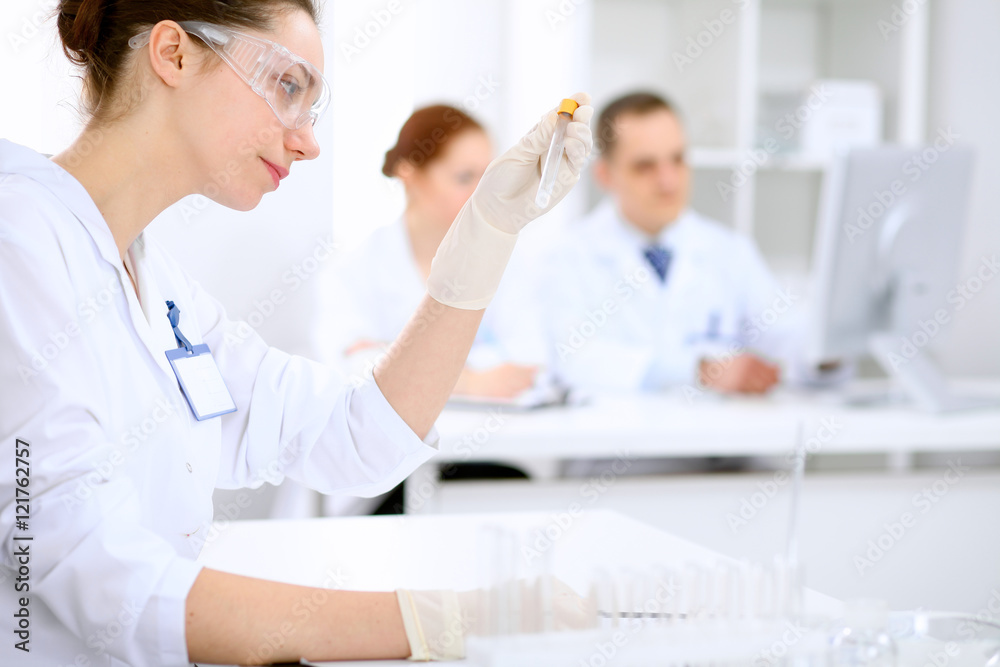 Scientific research team with clear solution in laboratory Scientific research team with clear solution in laboratory