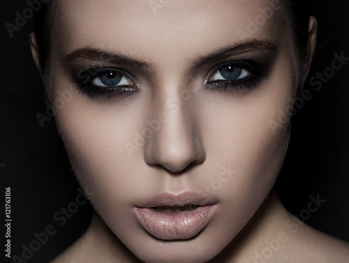 Bilde på lerret Beautiful woman model smokey eyes makeup closeup on black