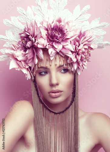 Fototapeta Naklejka Na Ścianę i Meble -  Beautiful woman with flower crown and makeup on pink background