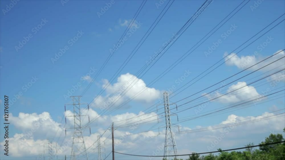 Miles of overhead power lines create a grid of electrical transmission along a stretch of highway. Miles of overhead power lines create a grid of electrical transmission along a stretch of highway.