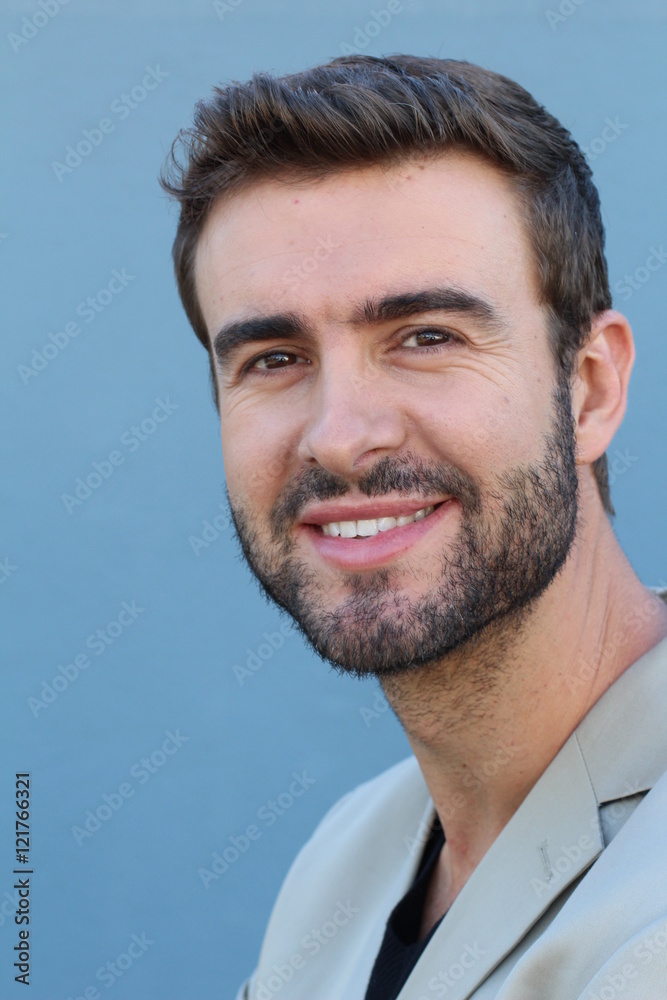 Fototapeta premium Headshot smiling modern man, creative professional isolated on blue wall background