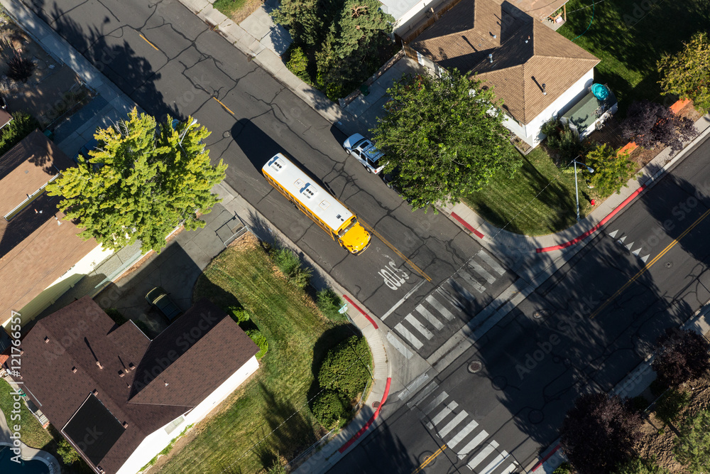 Overhead view of a school bus picking up children in a neighborhood Overhead view of a school bus picking up children in a neighborhood