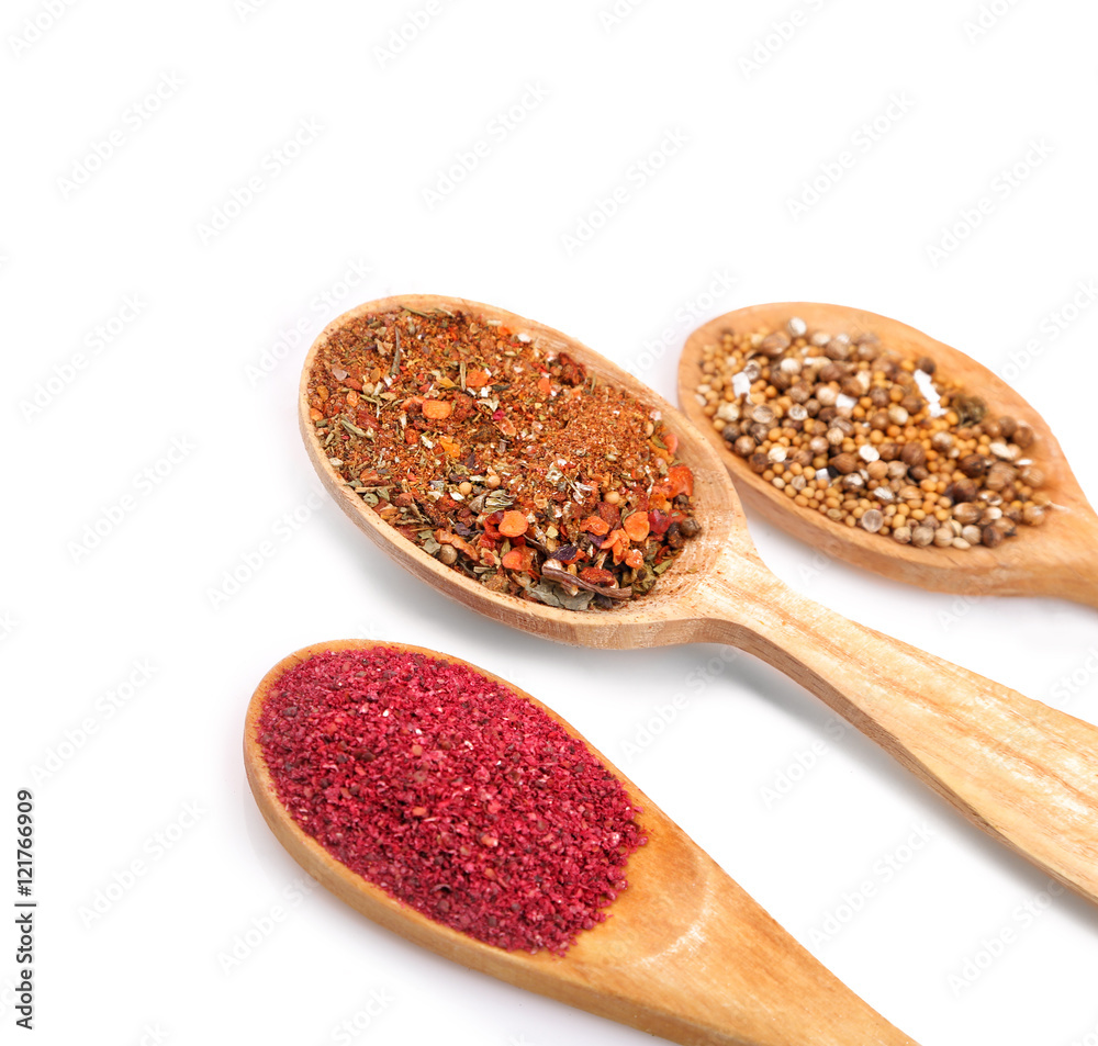 Fototapeta Different spices in spoons on white background