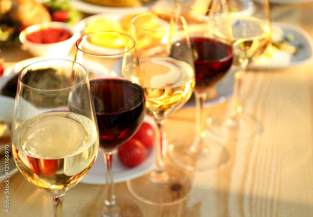 Glasses of different wine on wooden table Glasses of different wine on wooden table
