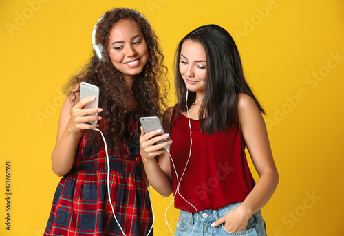 Beautiful girls listening m...