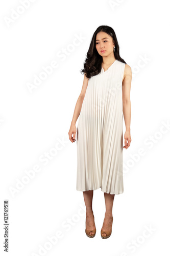 Young Asian woman in white dress looking down at the blank space on white background