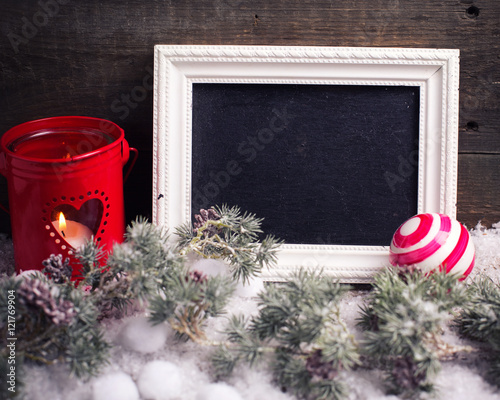 Empty blackboard, candle in lantern,  christmas balls and branch photo