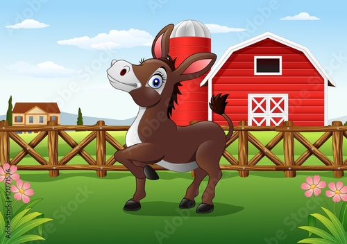Cartoon happy donkey with farm background

