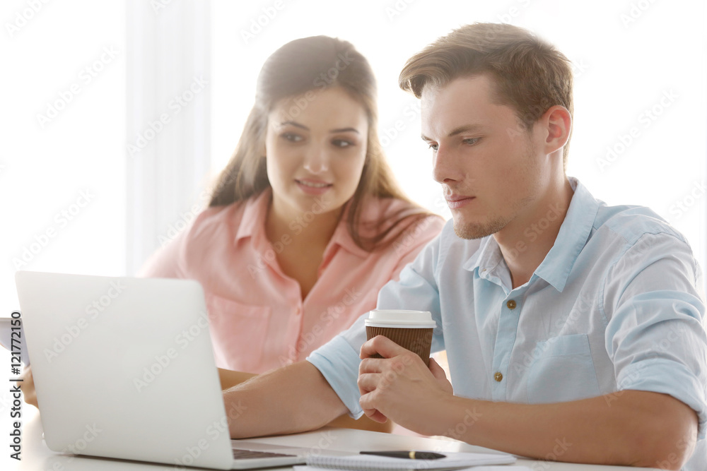Beautiful woman with handsome man discussing business ideas in office