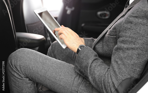 Businessman with tablet in a car © Africa Studio