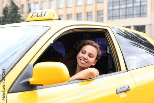 Female taxi driver in car