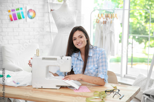 Pretty young dressmaker wit...