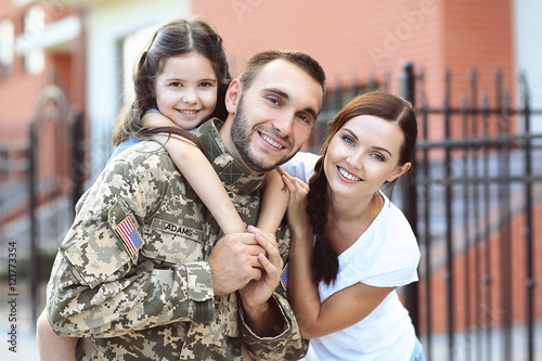 US army soldier with family on street photo