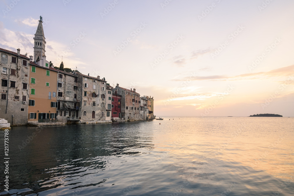 Sunset over the colourful buildings of the Valdibora side of the old town peninsular of Rovinj, Istria, Croatia
