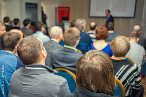 The audience listens to the acting in a conference hall